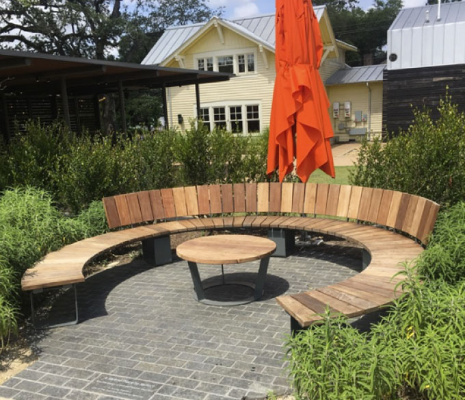 Open woodwork seating area with orange umbrella