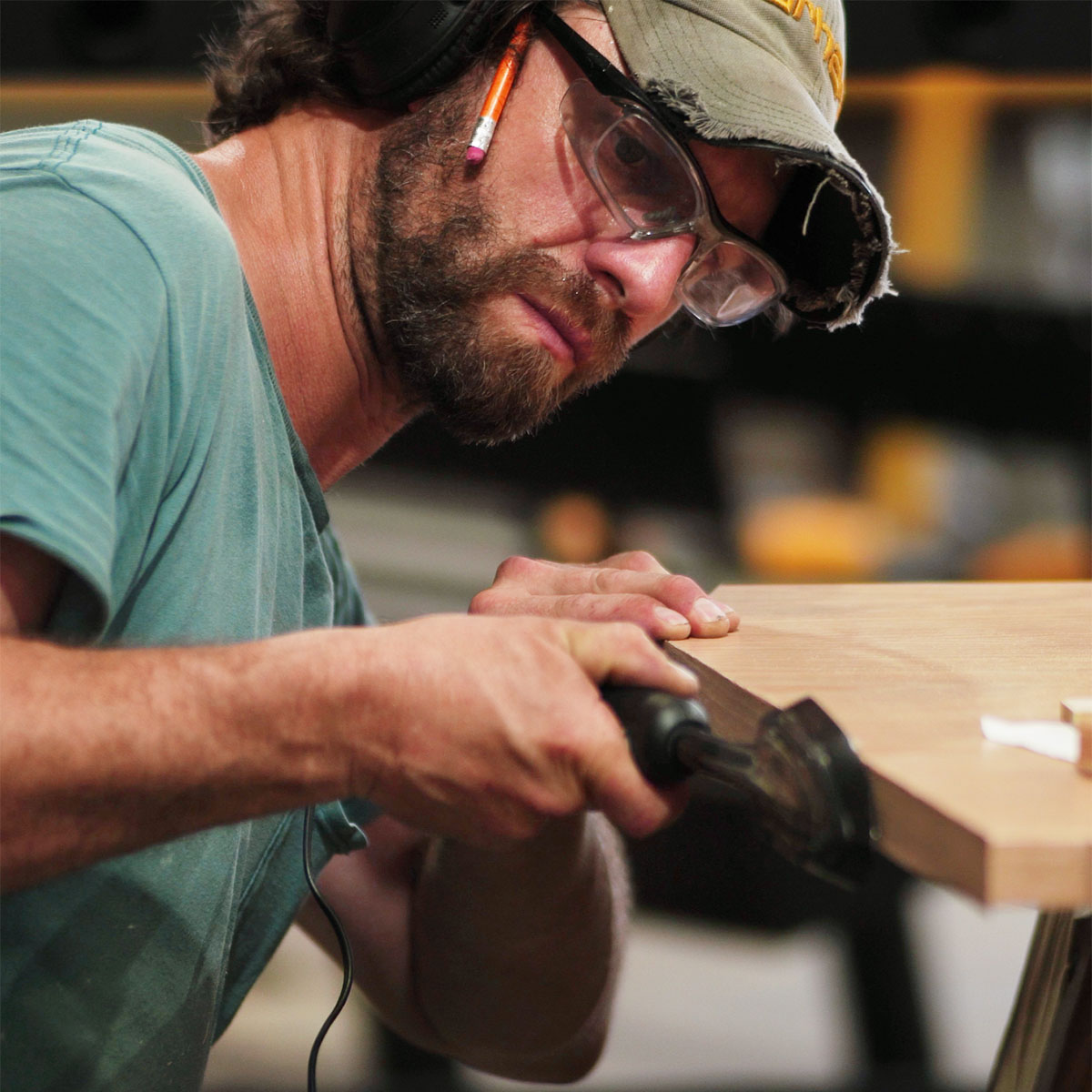 Home-Page-Woodworking Craftsman with pencil on right ear polishing woodwork edges