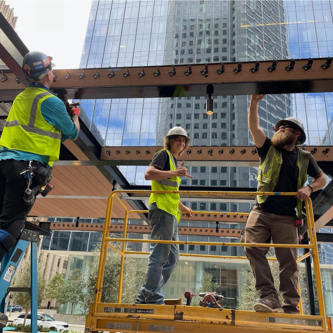 Construction team installing outdoor metalwork