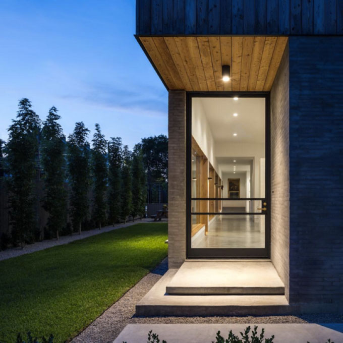 Glass door, hallway, and yard at dusk