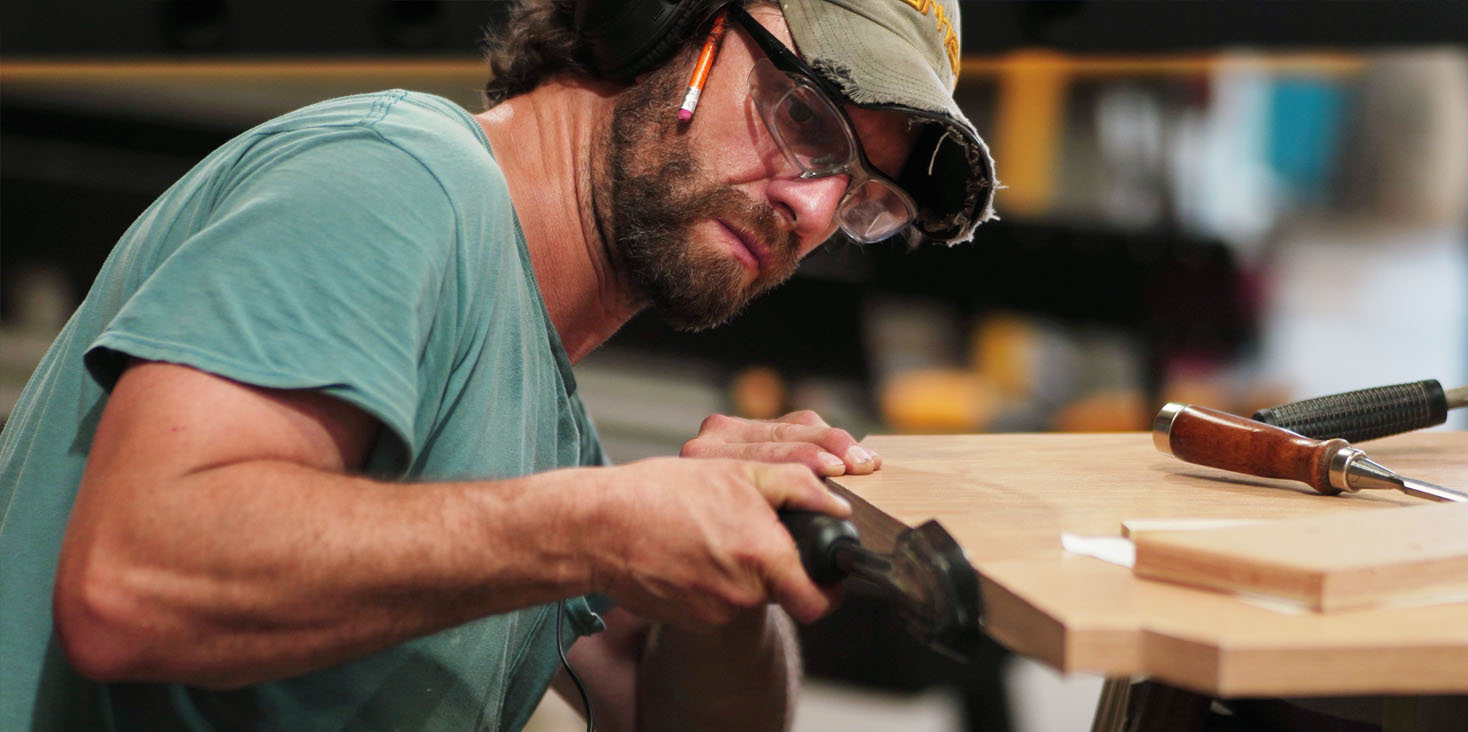 fabrication-of-imagination-B Craftsman with pencil on right ear polishing woodwork edges