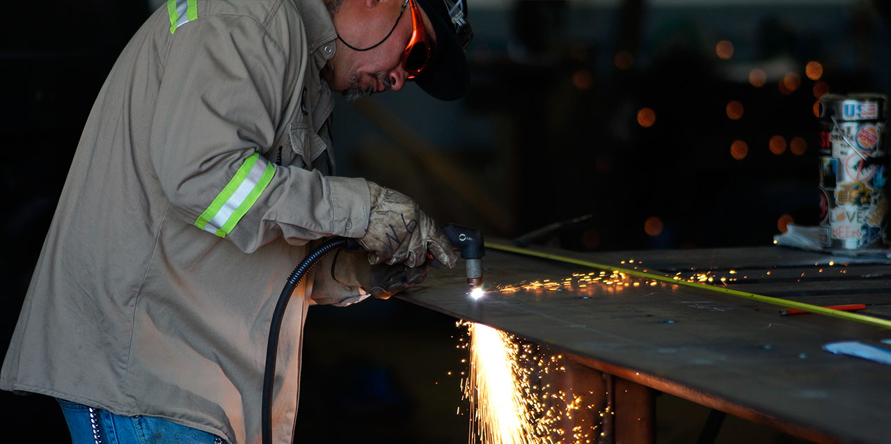 fabrication-of-imagination-B-1280x638 Craftsman with pencil on right ear polishing woodwork edges