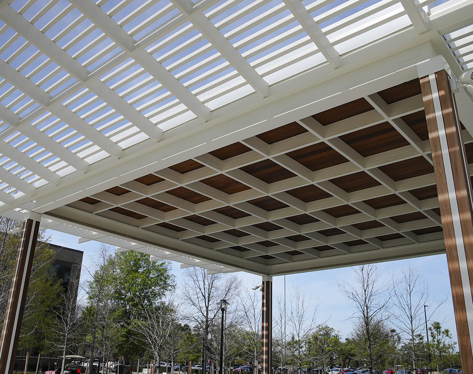 Top-tier metal fabrication in Houston showcasing an integrated cantilevered tube steel trellis and standing seam roof.