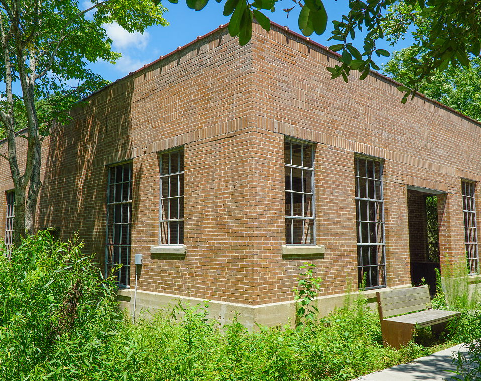 Exterior view of a brick building with large windows, part of the High Island Sky Walk project