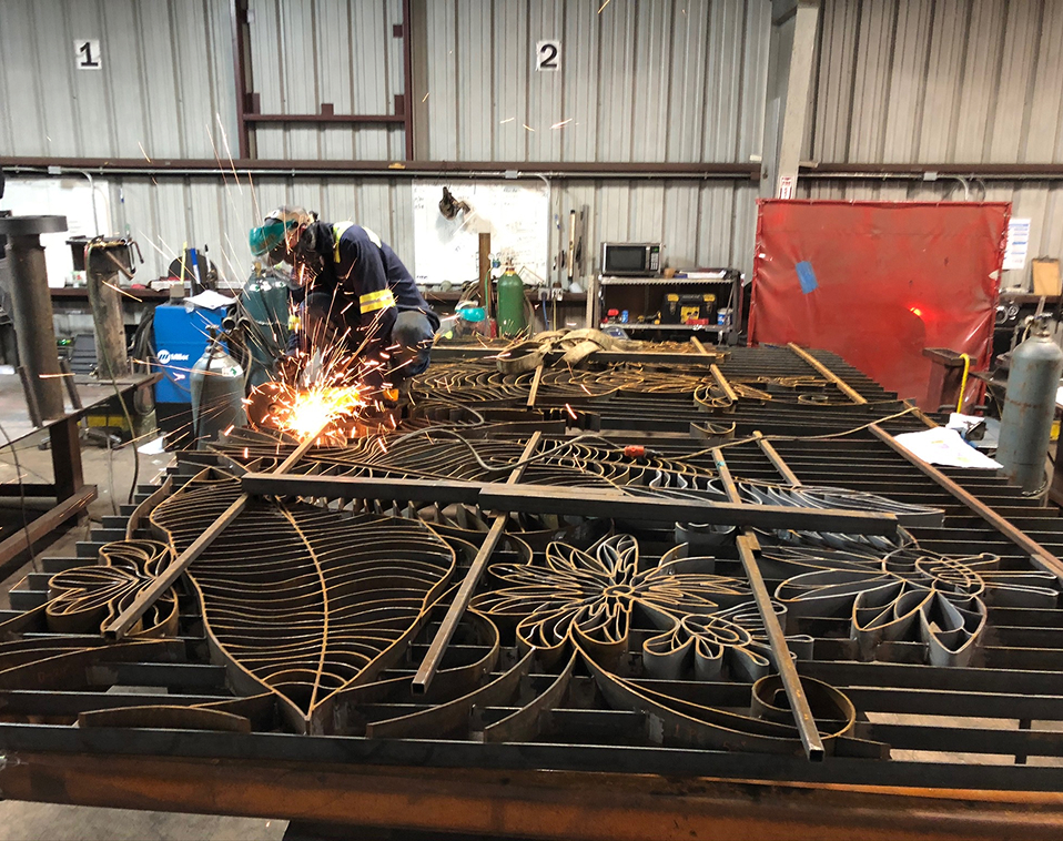 Renfrow+Co welder working on detailed decorative metal gates for the Houston Botanic Garden project