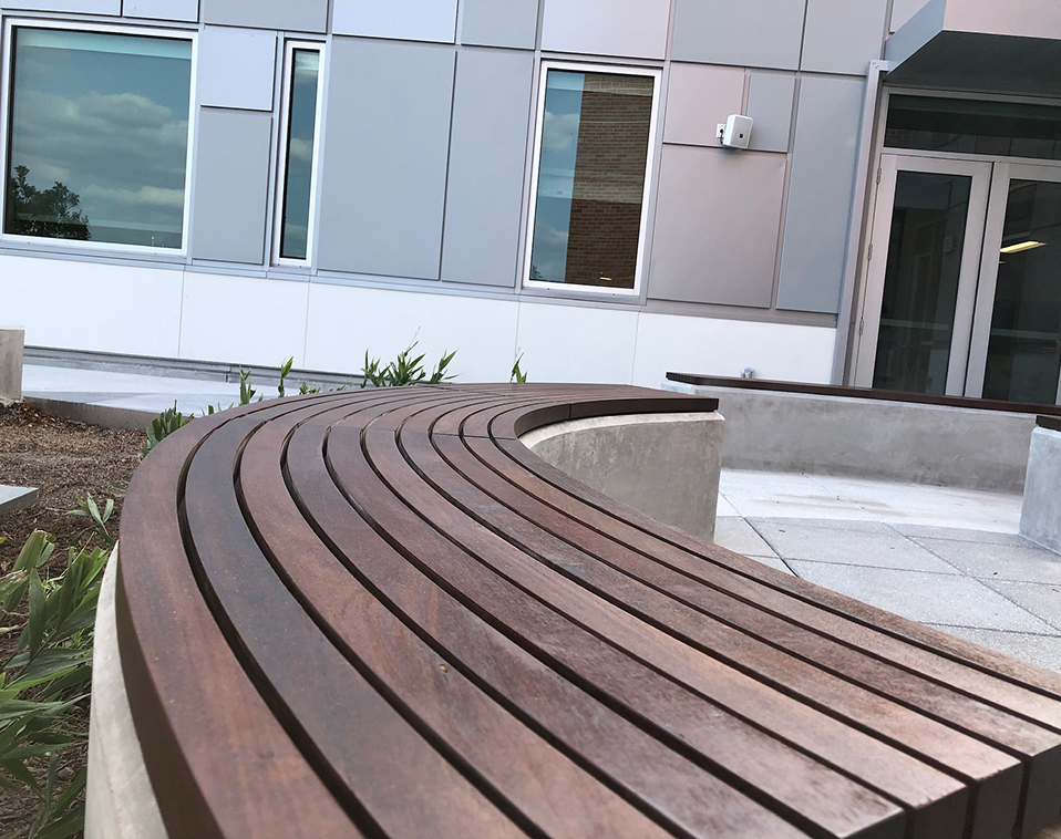 Close-up of weathered steel railing with cable rail design by Renfrow+Co, framing the elevated wooden walkway of the High Island Sky Walk