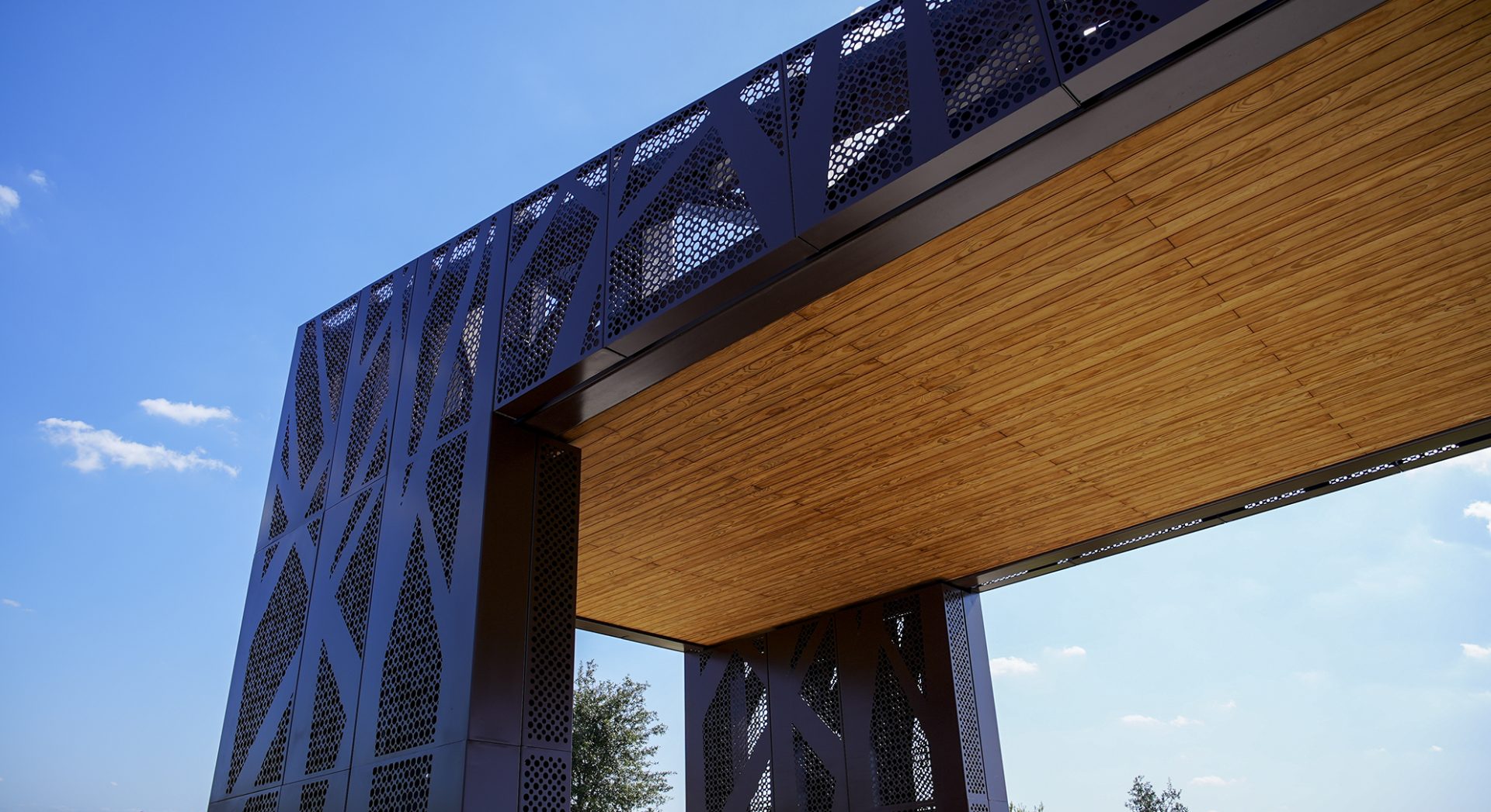 Close-up of intricate architectural metal work, unique perforated patterns, and laser-cut aluminum cladding fabricated by Renfrow+Co.