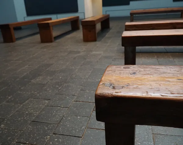 Close-up of refurbished wooden benches inside the Rothko Chapel, showing the intricate texture and patina from Renfrow+Co's restoration work Close-up of refurbished wooden benches inside the Rothko Chapel, showing the intricate texture and patina from Renfrow+Co's restoration work