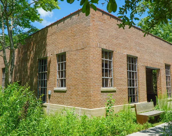 Exterior view of a brick building with large windows, part of the High Island Sky Walk project
