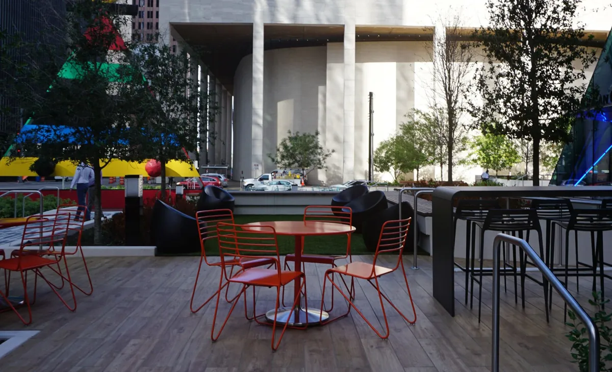 Modern patio setup with orange seating and railings designed and installed by Renfrow+Co at JPMorgan Chase Tower