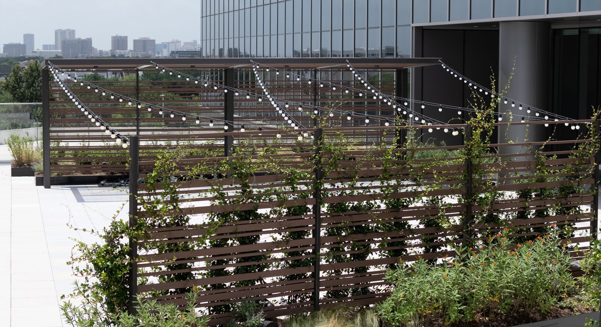 Engineered wood slat wall with steel columns matching the outdoor deck pavilion at Service Corporation International's Houston headquarters. Engineered wood slat wall with steel columns matching the outdoor deck pavilion at Service Corporation International's Houston headquarters.