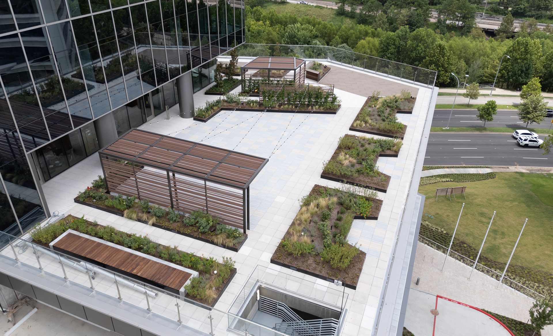 Class A corporate podium deck along Buffalo Bayou featuring custom outdoor architectural metal work and site furnishings in Houston.